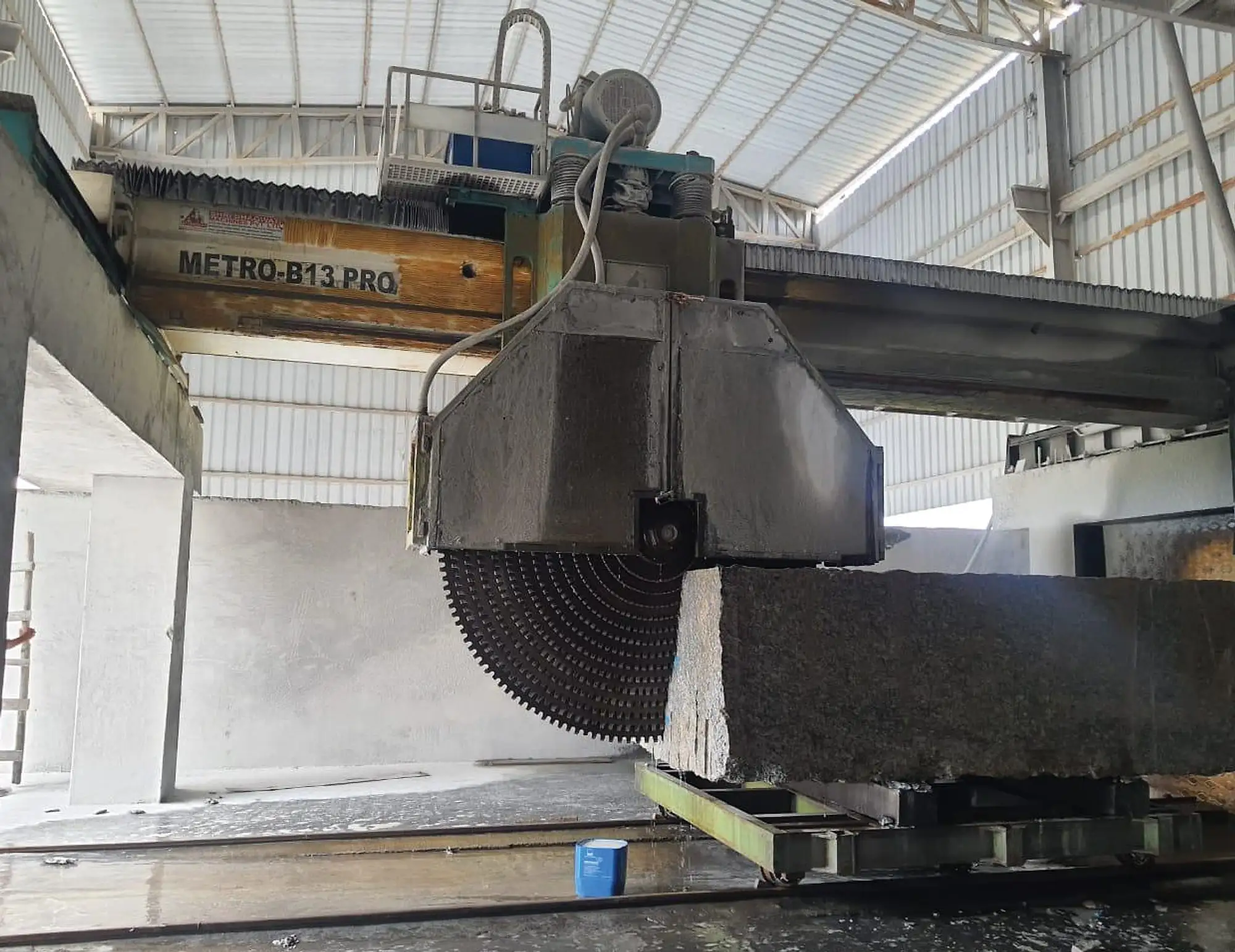 Multi-blade block cutter sawing a granite block