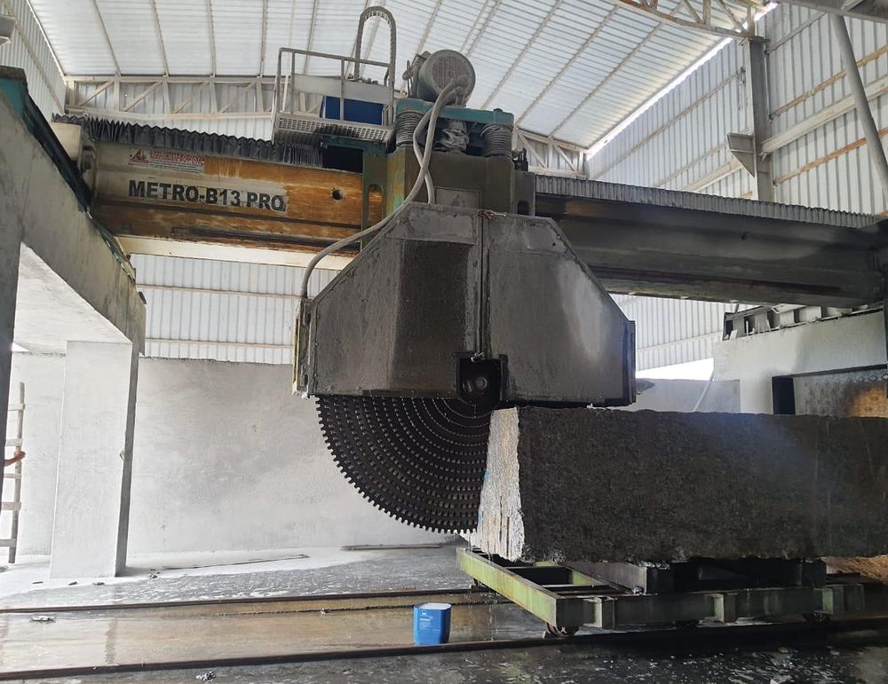 Block cutter sawing a granite block