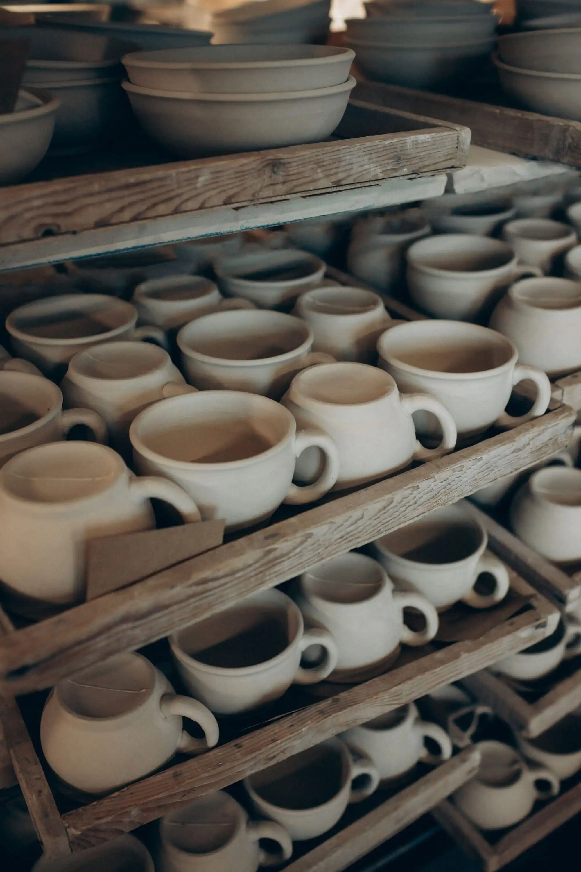 Ceramic cups and bowls on shelves