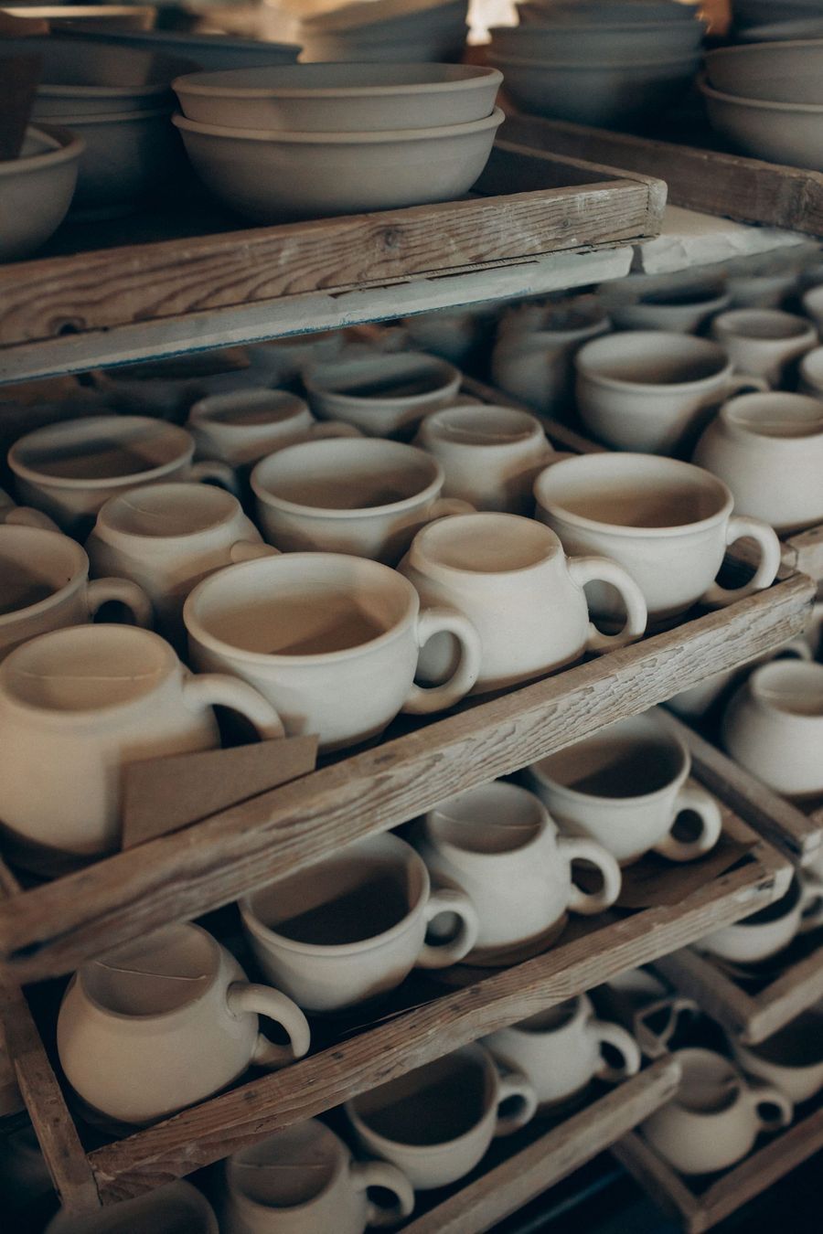 Ceramic cups and bowls on shelves