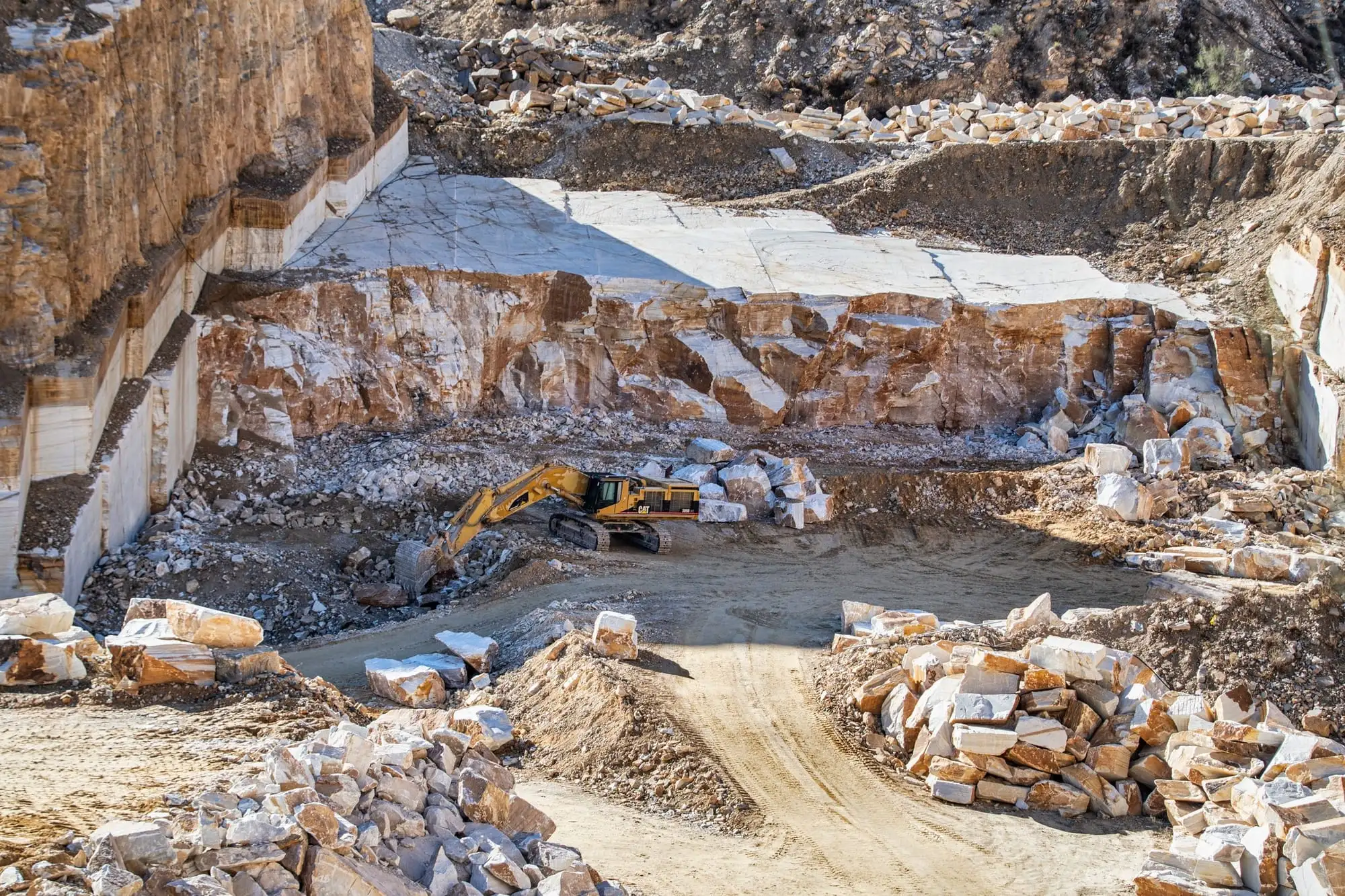 Excavator working in a large stone quarry