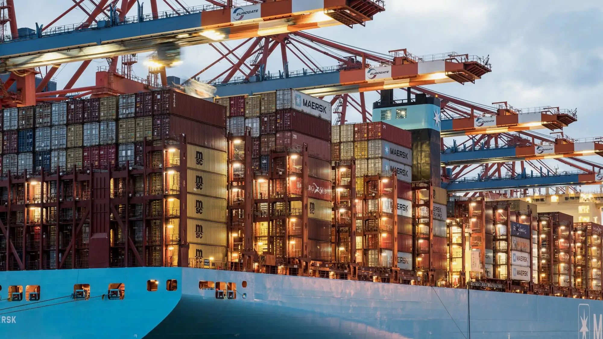 Container ship loaded with containers, lit at night